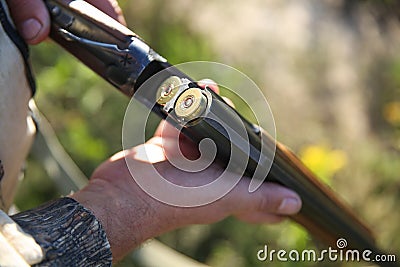 Manâ€™s hands holding a loaded hunting rifle Stock Photo